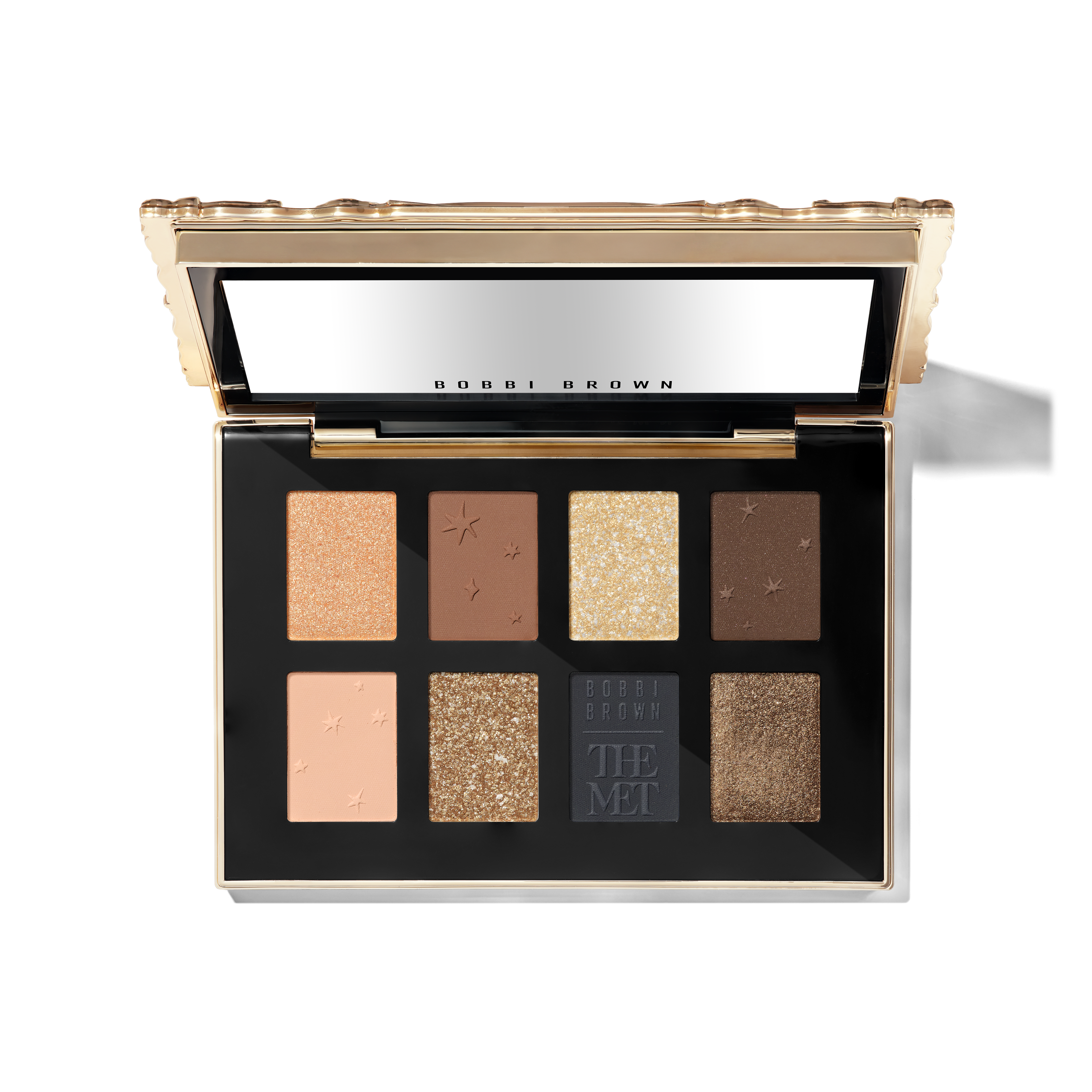 Open Bobbi Brown x The Met palette showing eight neutral, metallic and deep-blue eyeshadows.