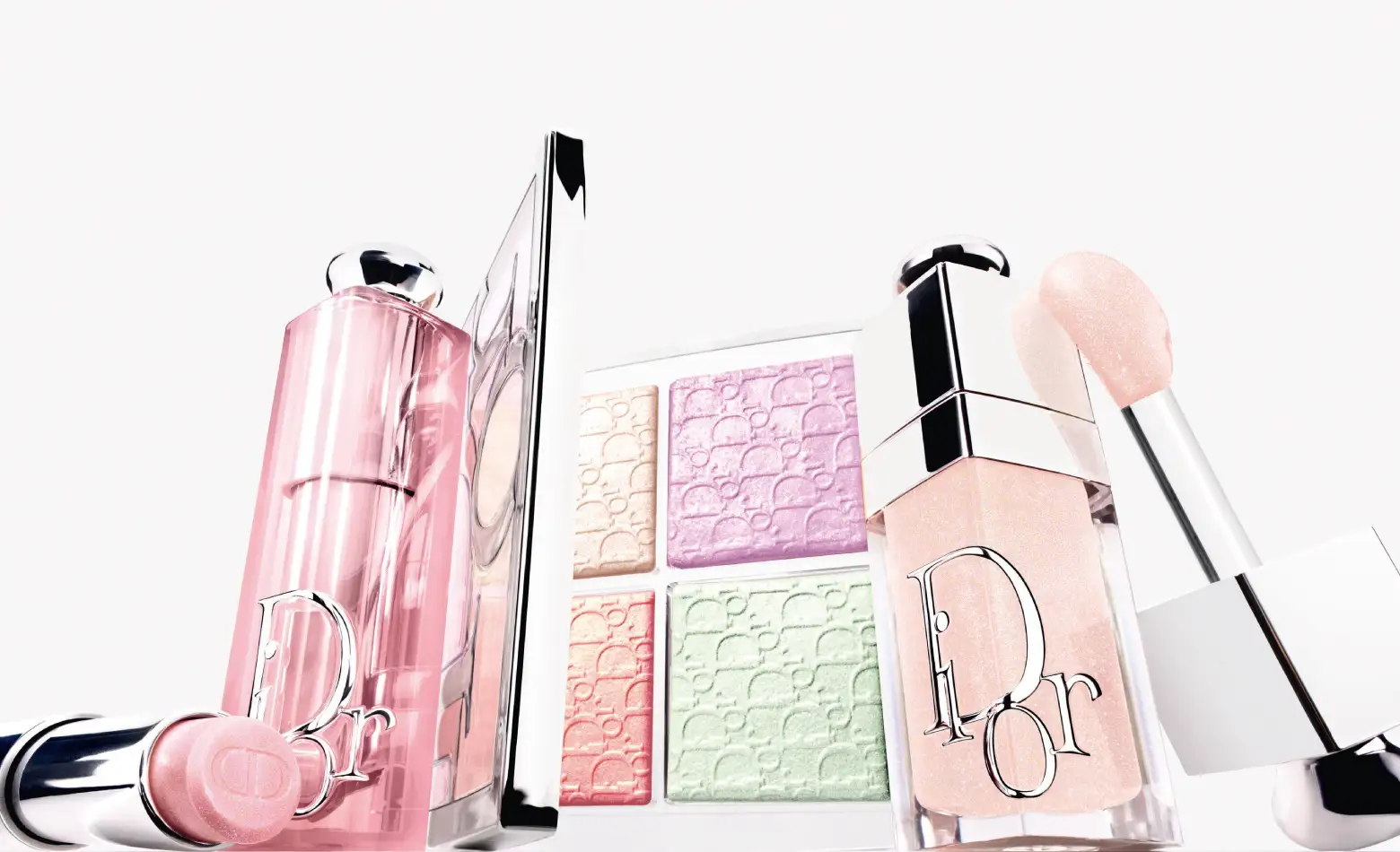 Dior Icy Rosy lip balm, open four-colour palette and lip oil arranged against a pale background.