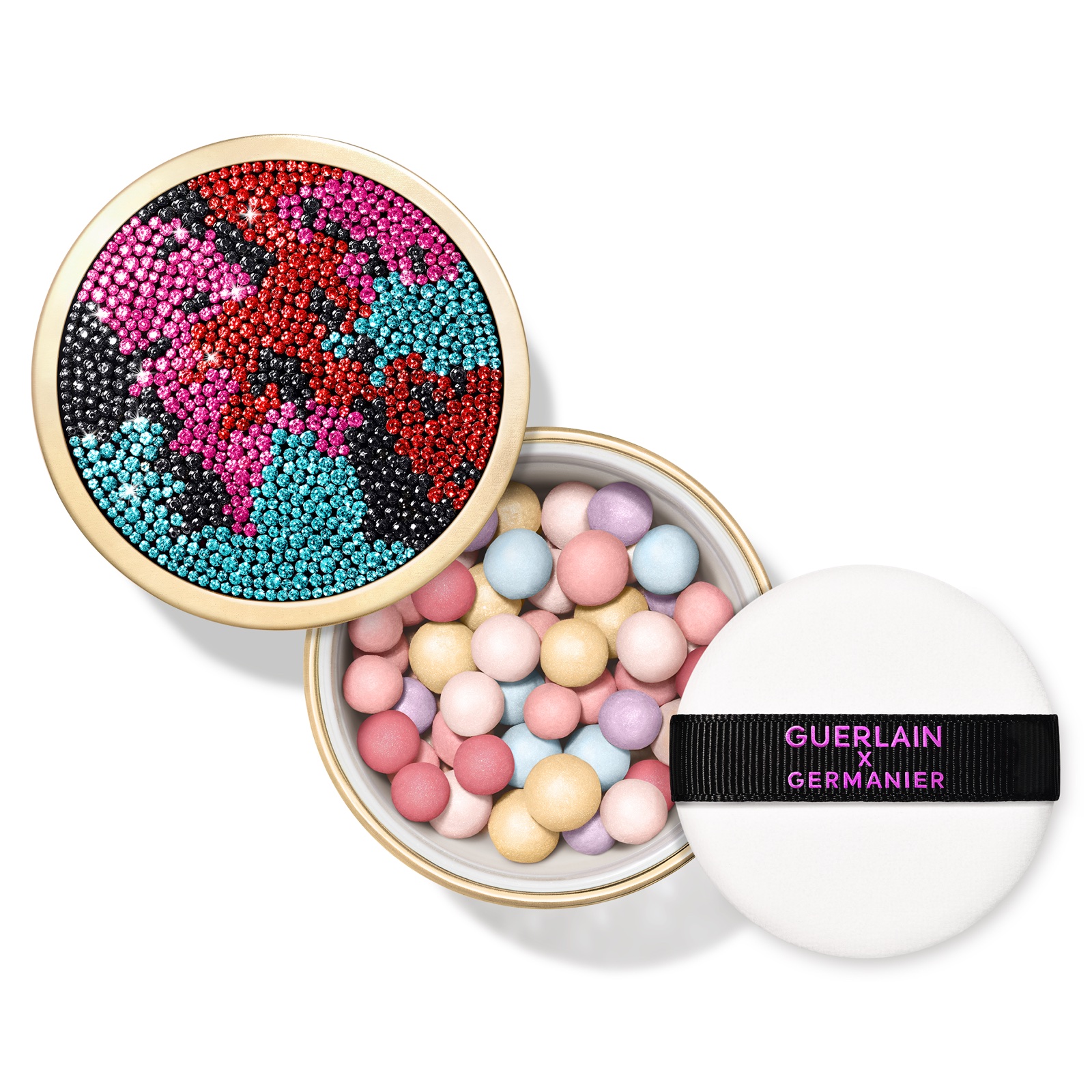 Guerlain Météorites Dreamlight pastel powder pearls in an open round pot, beside its rhinestone lid and white powder puff.