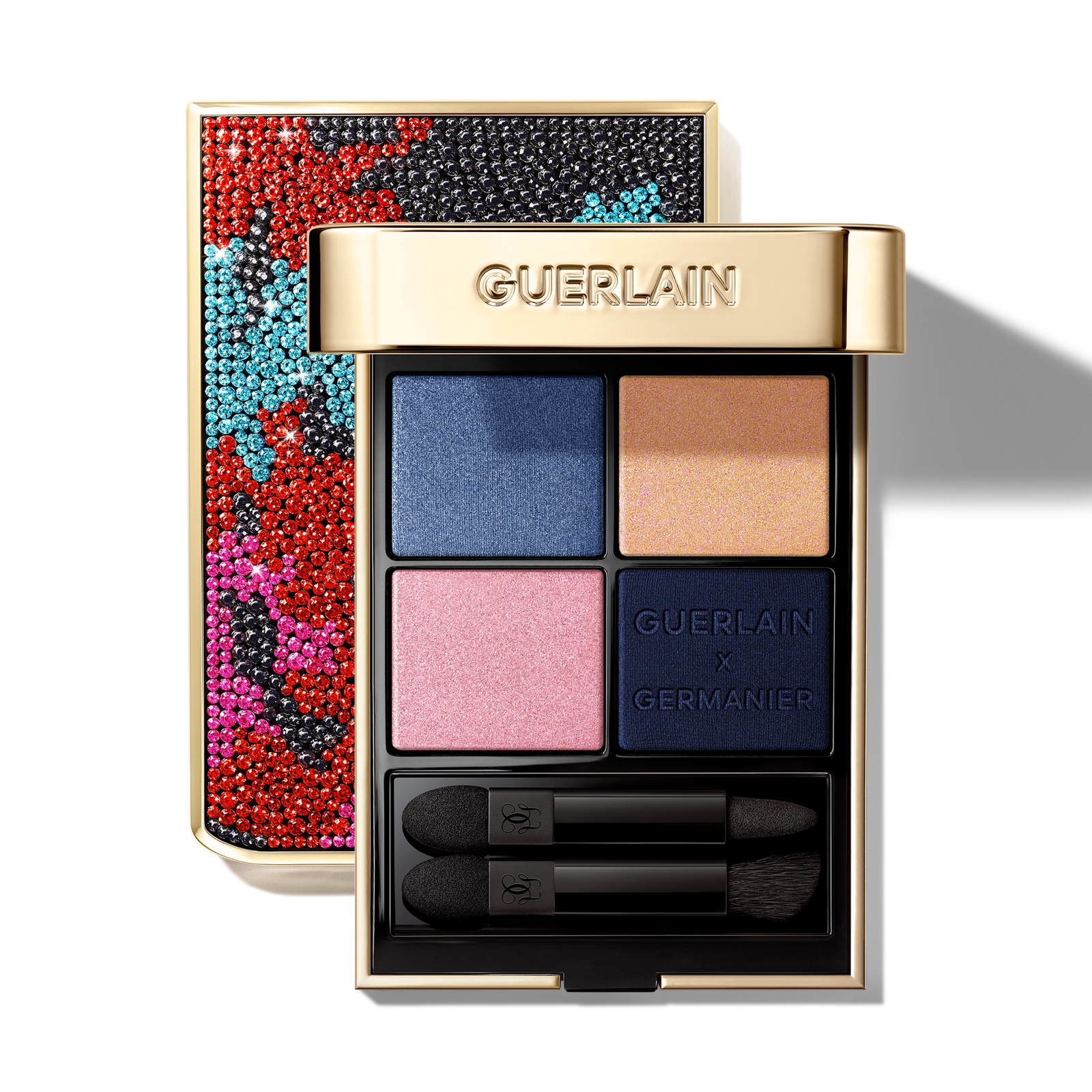 Open Guerlain Ombres G 300 Mystery eye palette with blue, gold and pink shades, two applicators and its multicoloured rhinestone lid.