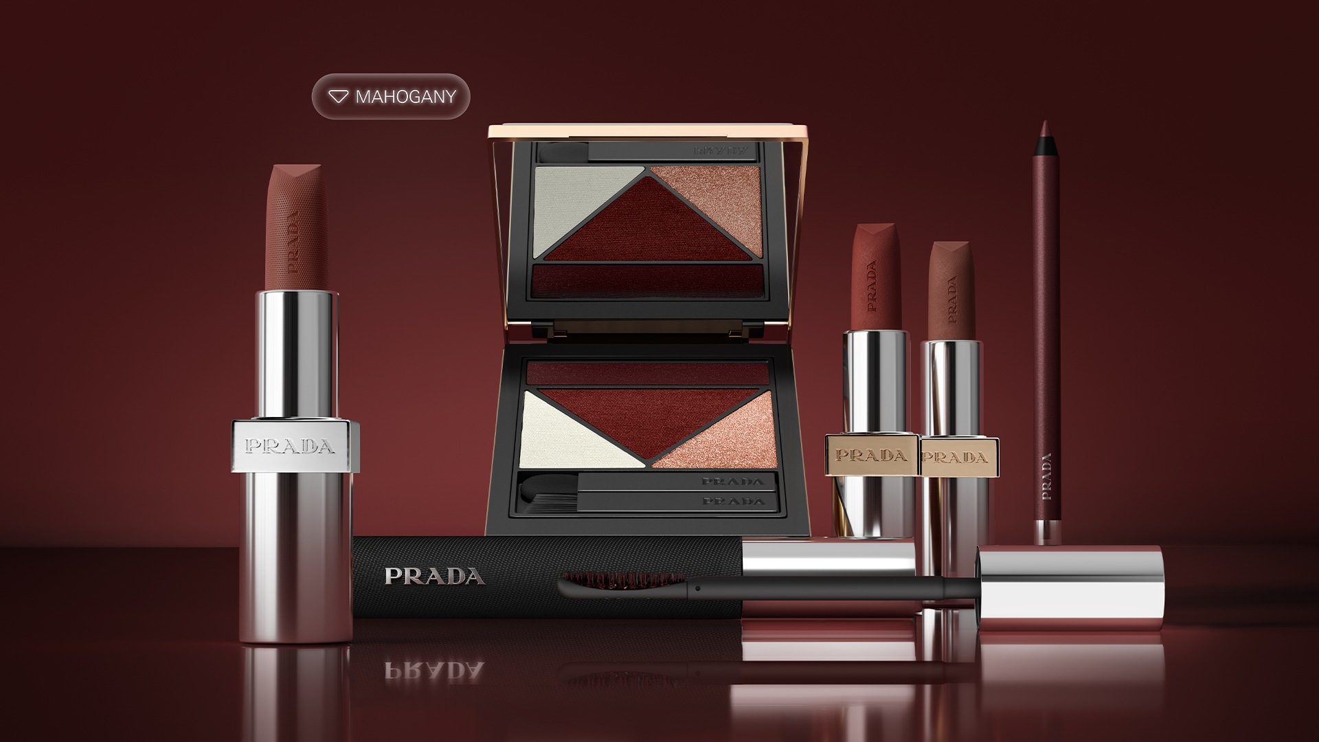 Prada Mahogany makeup arranged on a reflective burgundy surface, with an open eye palette, three lipsticks, an eye pencil and mascara.